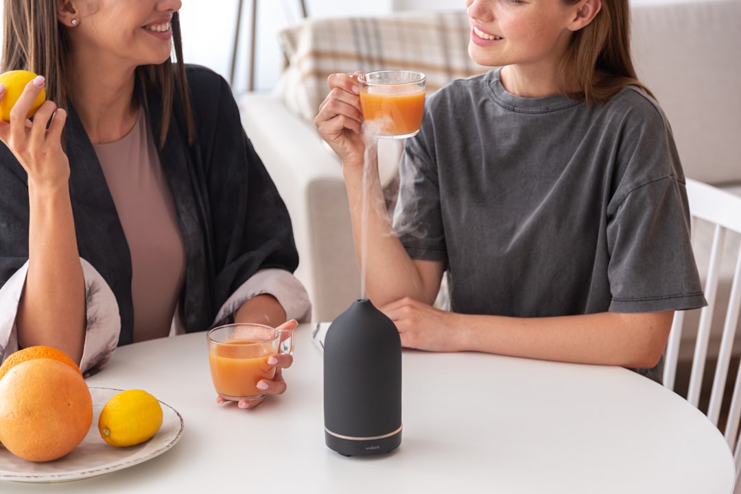 音声AIアシスタントの進化：Alexaが拓くスマートライフと未来の買い物体験 - a couple of women sitting at a table with oranges