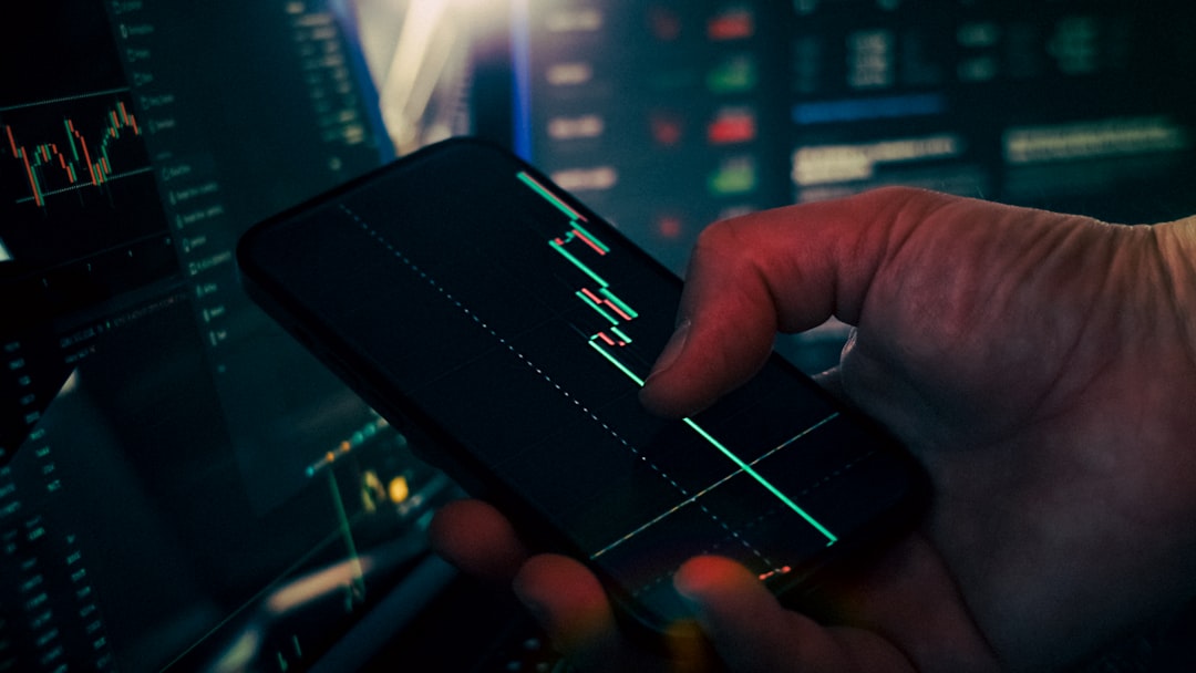 【ChatGPT】最新アップデートリリース！金融特化型機能と性能向上を解説 - Hand smartphone trading chart technology finance background. Close-up of a person analyzing candlestick stock chart