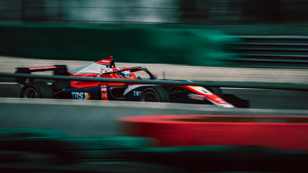 F1を支配するAI戦略：アストンマーティンに学ぶデータ駆動の勝利の方程式 - a man driving a race car on a track